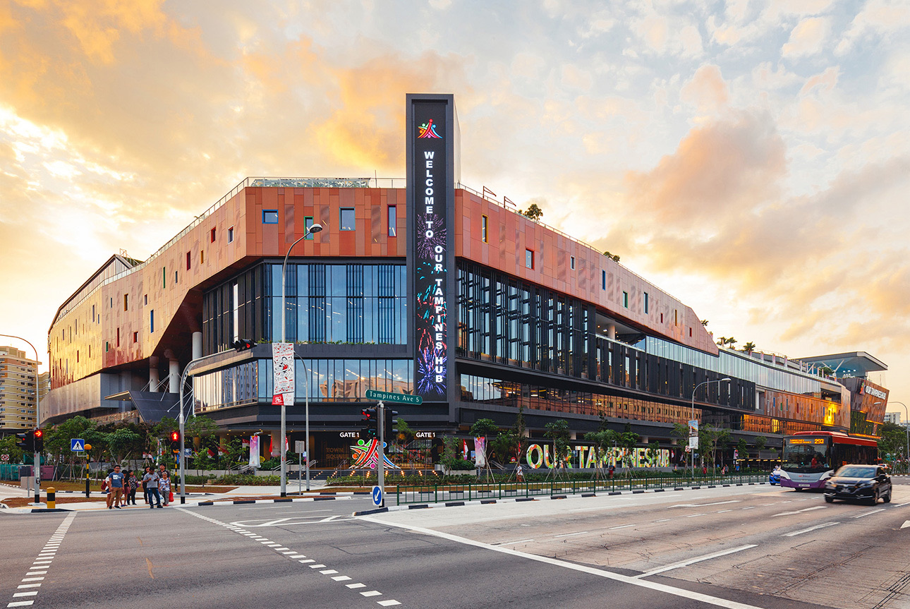 Gate 1 of Our Tampines Hub on Tampines Avenue 5 at sunset, with the Welcome to Our Tampines Hub tower